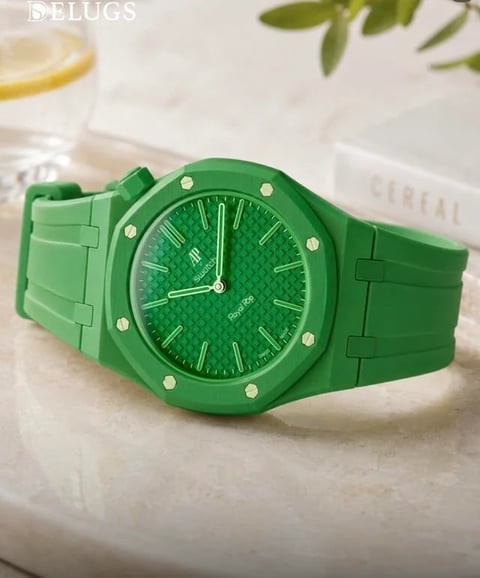 Bright green watch with matching band displayed on white surface with lemon and green leaves in background